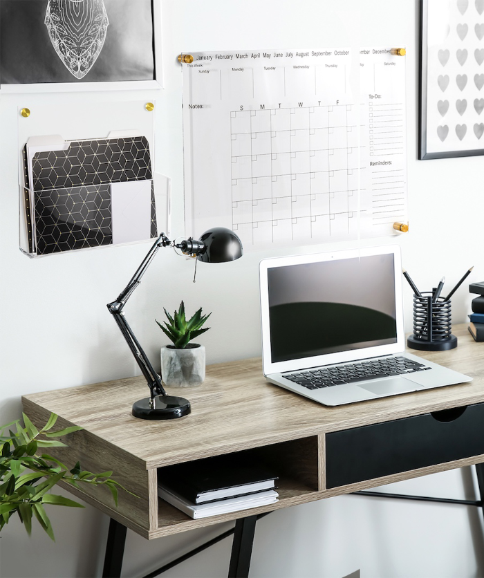Desk scene with one acrylic wall file holder next to the acrylic wall calendar, showing how each product compliments one another in a sleek modern office. 
